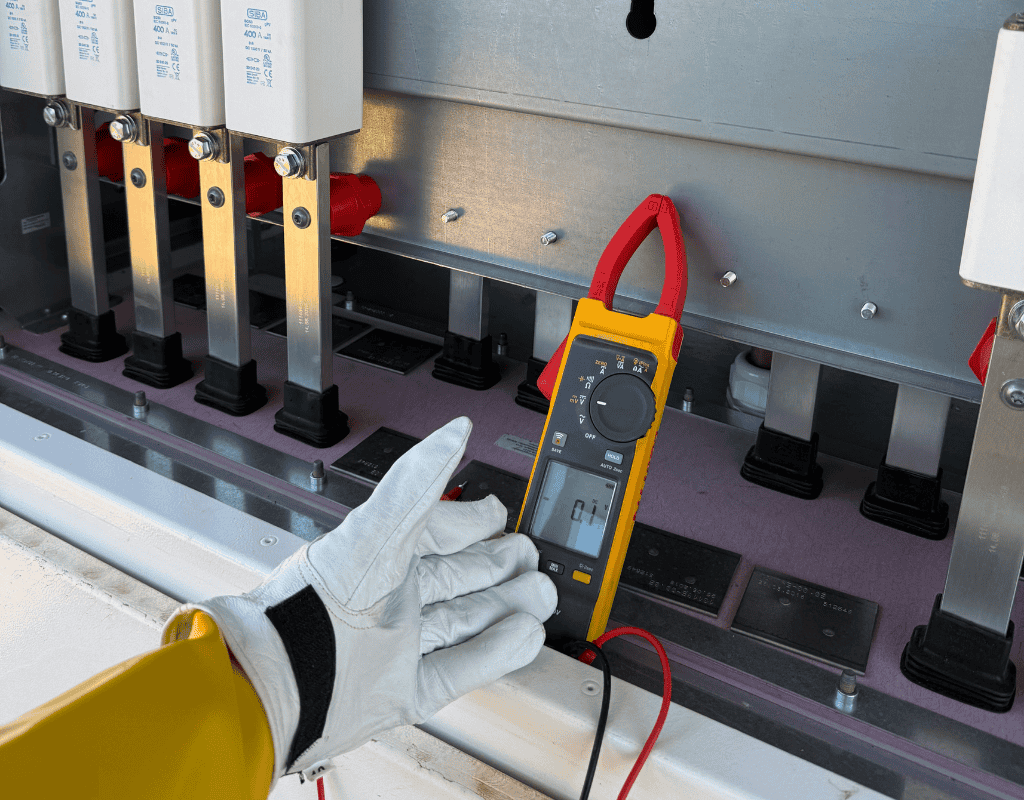 technician using multimeter on commercial electrical system in Columbia MO