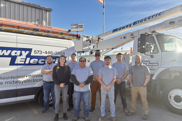 midway electric team standing in front of service trucks in Columbia MO