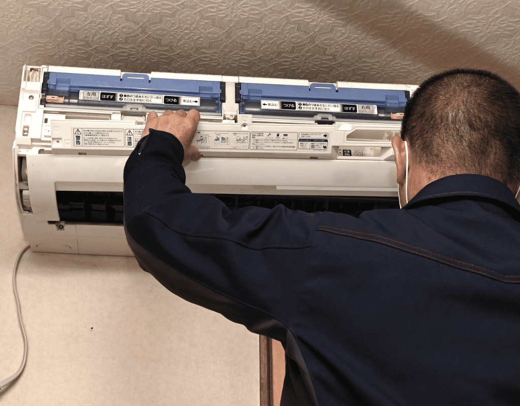 technician cleaning and maintaining air conditioning system in Columbia MO