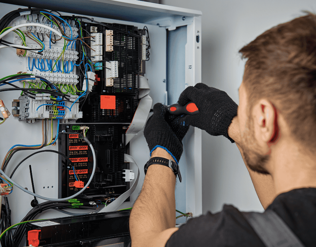 electrician working inside electrical panel upgrading wiring in Columbia MO