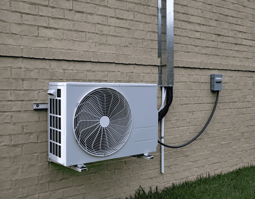 exterior HVAC condenser unit installed and repaired on brick wall in Columbia MO